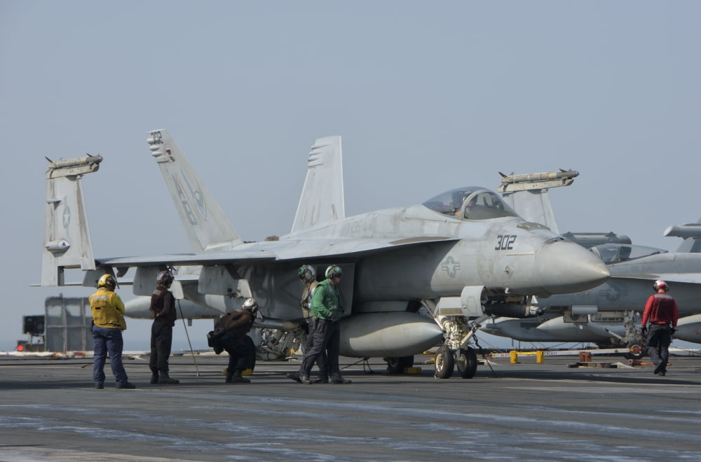 An FA-18F Super Hornet on the flight deck of USS Theodore Roosevelt Canvas Art - Giovanni CollaStocktrek Images (17 x 12)