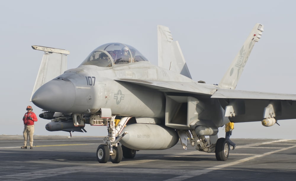 An FA-18F Super Hornet on the flight deck of USS Theodore Roosevelt Canvas Art - Giovanni CollaStocktrek Images (18 x 11)