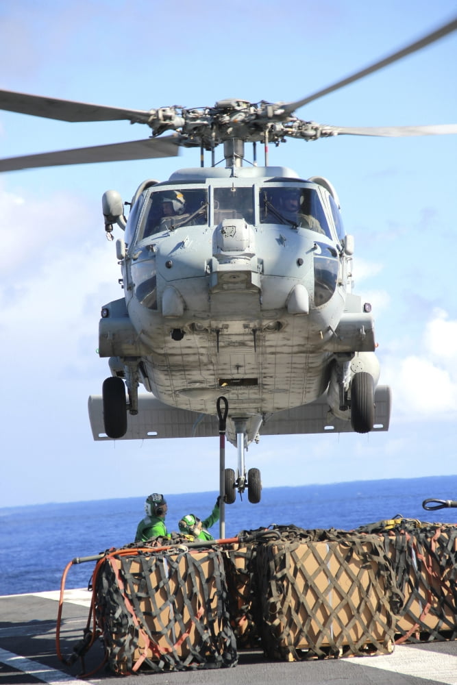 An HH-60H Sea Hawk helicopter picks up supplies from the flight deck Canvas Art - Stocktrek Images (23 x 34)