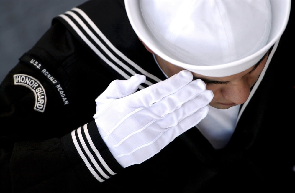 An Honor Guard member renders a salute during a burial at sea ceremony Canvas Art - Stocktrek Images (35 x 23)