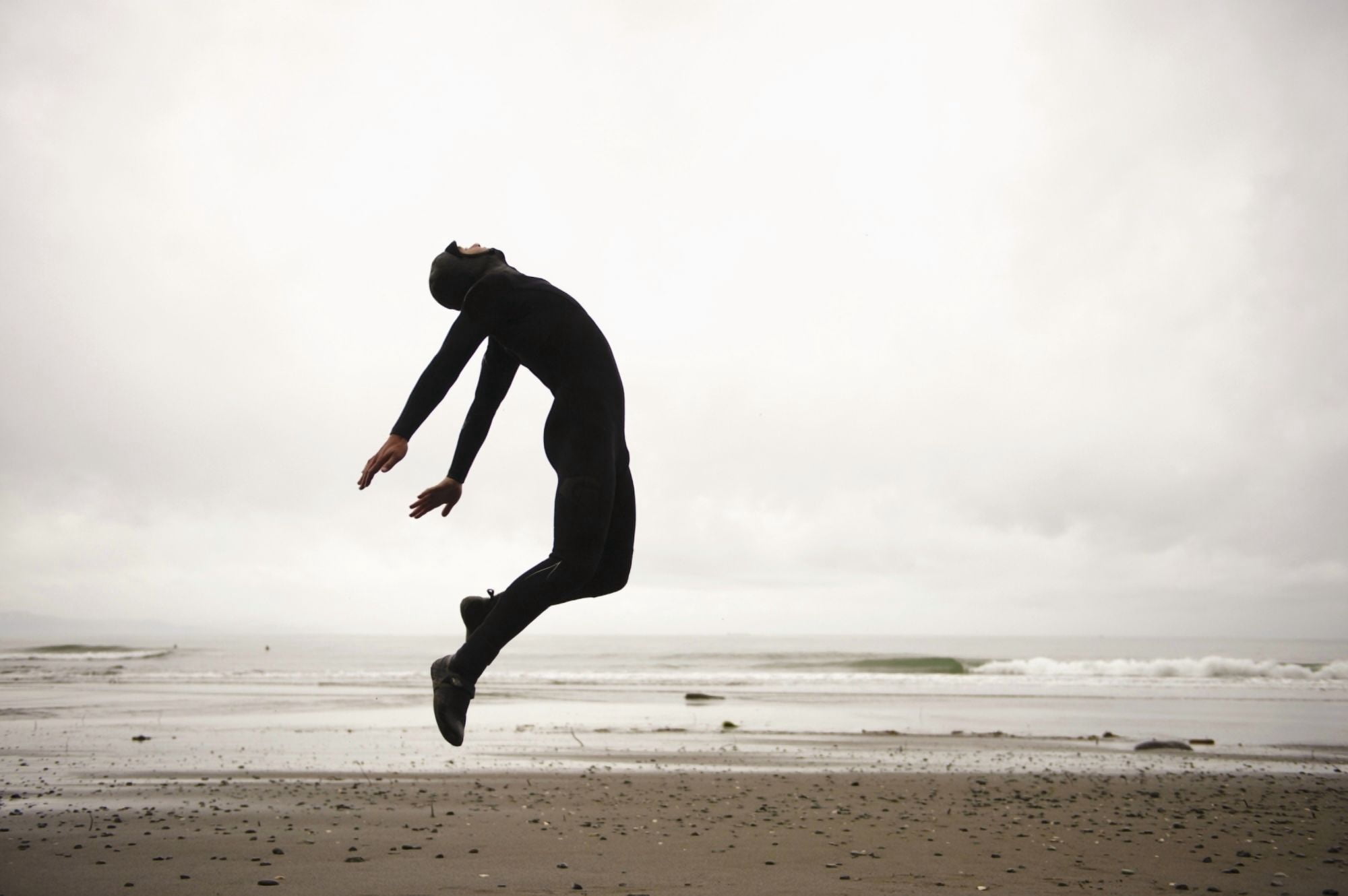 An Individual Wearing A Wet Suit Jumping In Mid-Air On A Beach French Beach British Columbia Canada Canvas Art - Helene Cyr Design Pics (19 x 12)