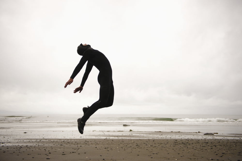 An Individual Wearing A Wet Suit Jumping In Mid-Air On A Beach French Beach British Columbia Canada Canvas Art - Helene Cyr Design Pics (38 x 24)