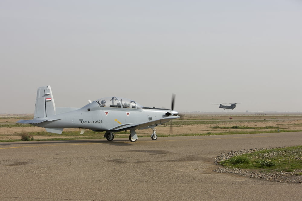 An Iraqi Air Force T-6 Texan trainer aircraft taxis out for a flight over Tikrit Iraq Canvas Art - Terry MooreStocktrek Images (35 x 23)