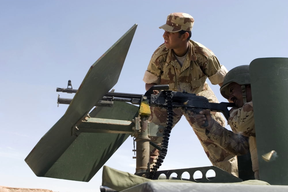 An Iraqi army instructor supervises an Iraqi army soldier with a PKM 762-mm machine gun Canvas Art - Stocktrek Images (34 x 23)