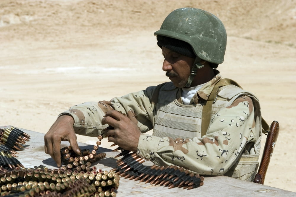 An Iraqi army soldier prepares belts of ammunition for his PKM 762-mm machine gun Canvas Art - Stocktrek Images (34 x 23)