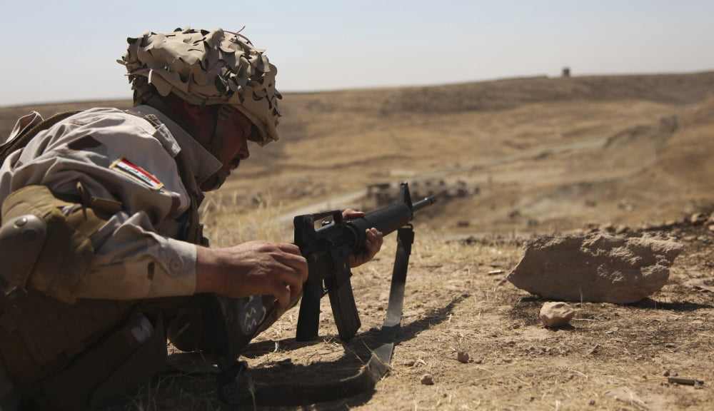 An Iraqi army soldier prepares to fire an M-16 rifle Canvas Art - Stocktrek Images (37 x 22)