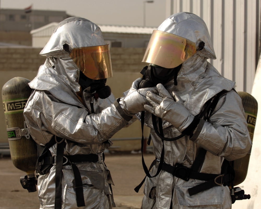 An Iraqi firefighter double checks his partners personal protective equipment Canvas Art - Stocktrek Images (31 x 25)