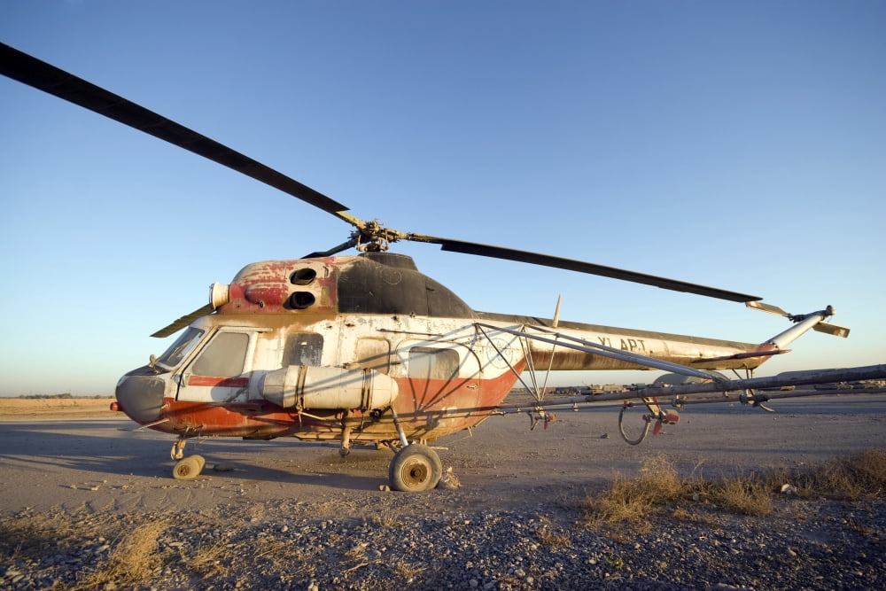 An Iraqi helicopter sits on the flight deck abandoned at Camp Warhorse Canvas Art - Terry MooreStocktrek Images (18 x 12)