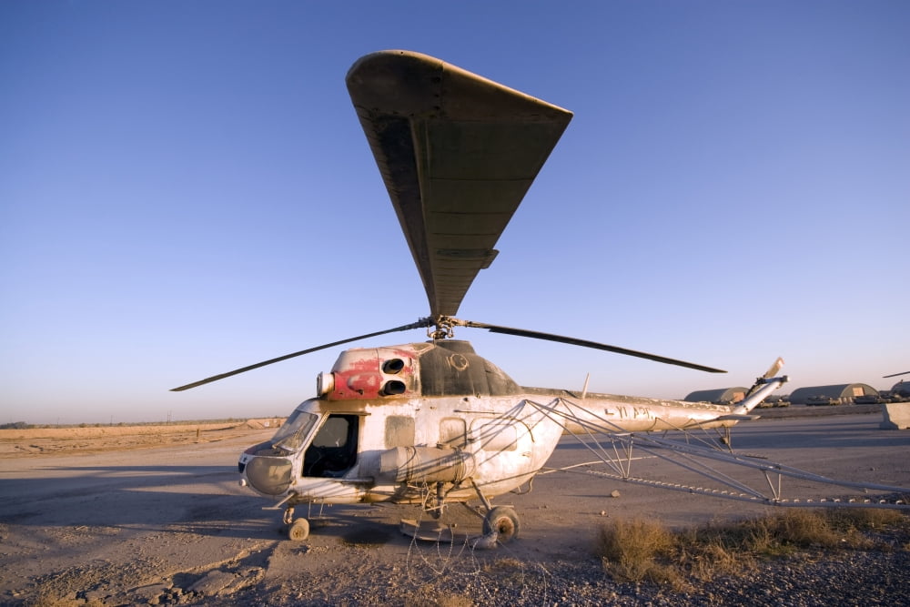 An Iraqi helicopter sits on the flight deck abandoned at Camp Warhorse Canvas Art - Terry MooreStocktrek Images (35 x 23)