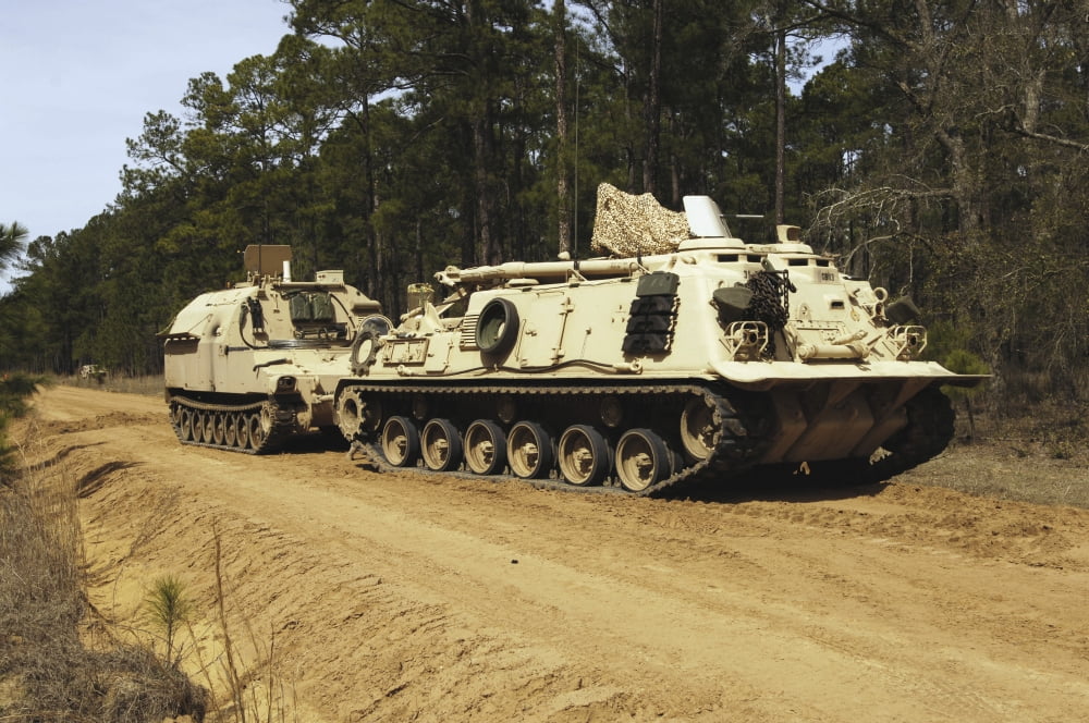An M-88 recovery vehicle begins to tow an M992 field artillery ammunition supply vehicle Canvas Art - Stocktrek Images (34 x 23)