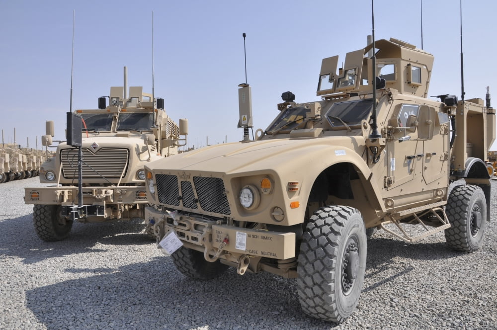 An M-ATV Mine Resistant Ambush Protected vehicle parked next to a MaxxPro MRAP Canvas Art - Stocktrek Images (34 x 23)