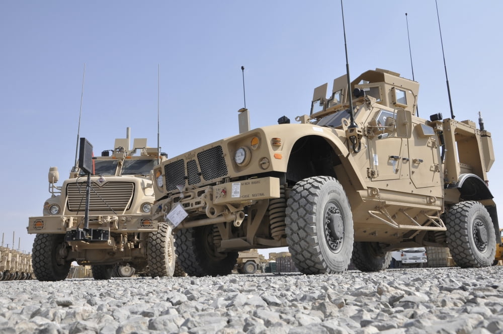 An M-ATV Mine Resistant Ambush Protected vehicle parked next to a MaxxPro MRAP Canvas Art - Stocktrek Images (34 x 23)