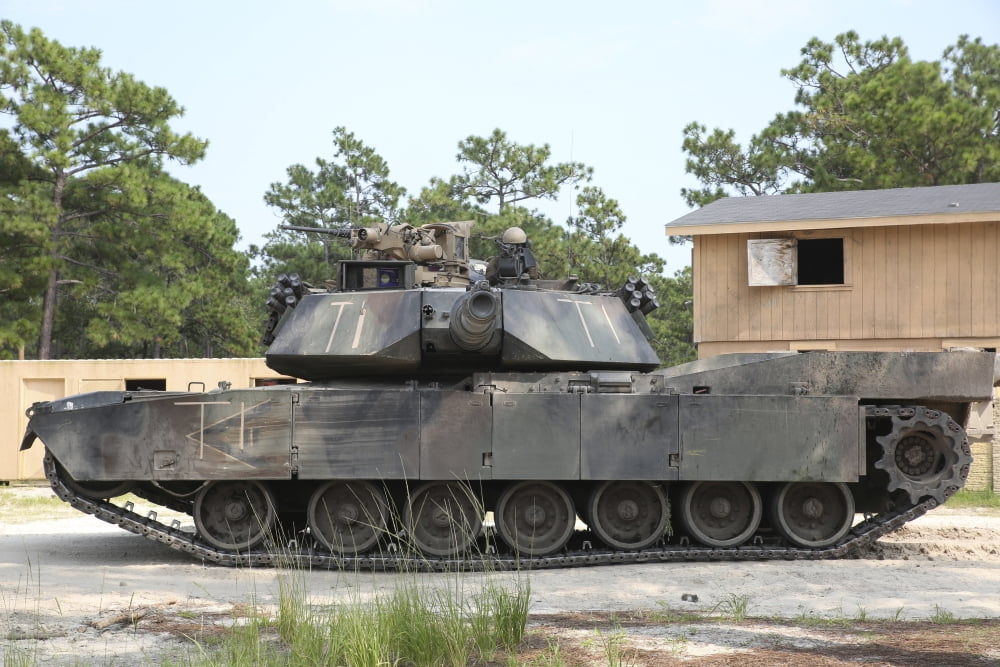 An M1A1 Abrams tank takes a defensive position on a simulated enemy town Canvas Art - Stocktrek Images (34 x 23)