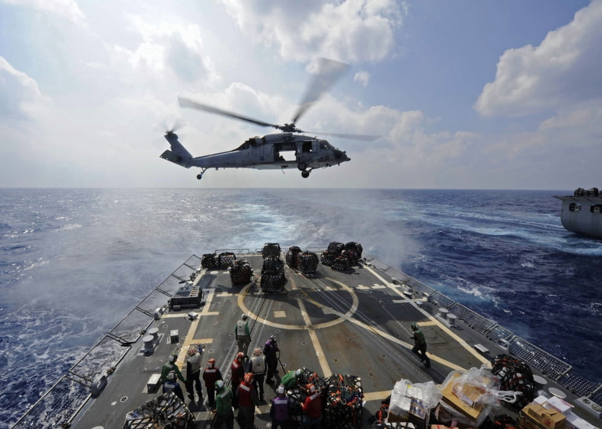 An MH-60R Sea Hawk transfers supplies to the flight deck of USS Wayne E Meyer Canvas Art - Stocktrek Images (34 x 24)