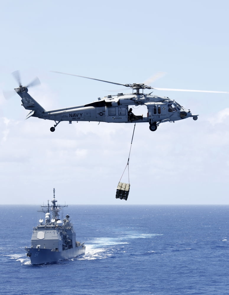 An MH-60S Sea Hawk helicopter flying in front of USS Gettysburg Canvas Art - Stocktrek Images (25 x 33)