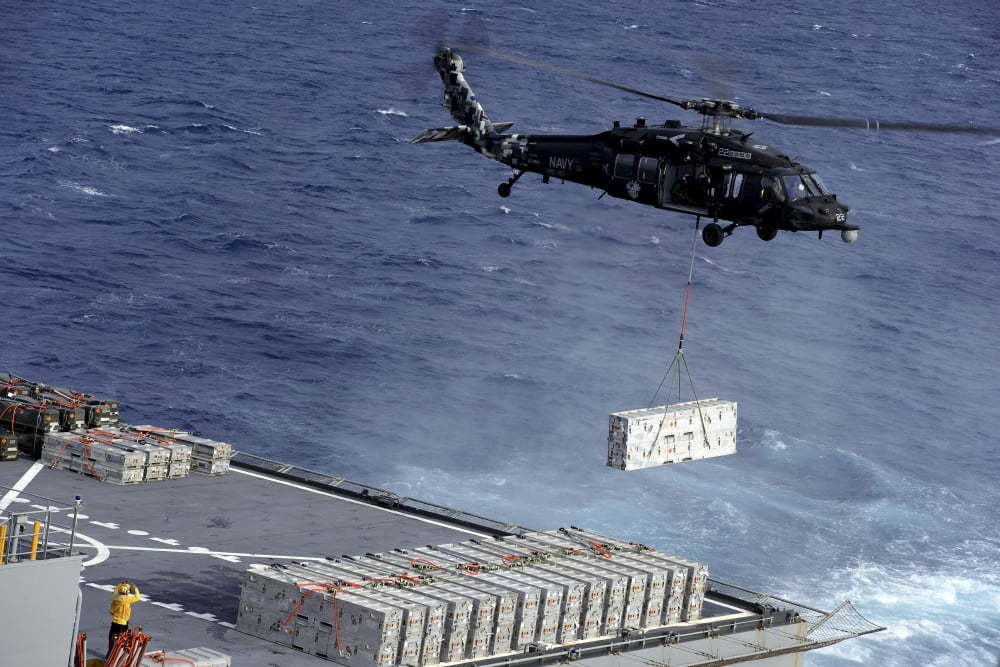 An MH-60S Sea Hawk helicopter picks up ammunition from USNS William McLean Canvas Art - Stocktrek Images (35 x 23)