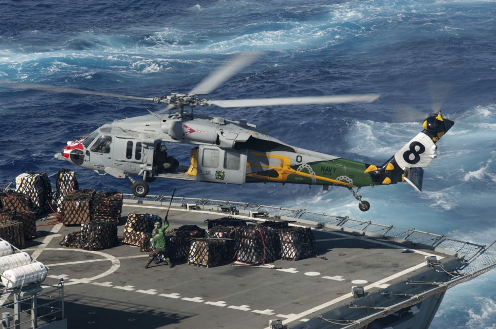 An MH-60S Sea Hawk helicopter picks up supplies from USNS Bridge Canvas Art - Stocktrek Images (35 x 23)