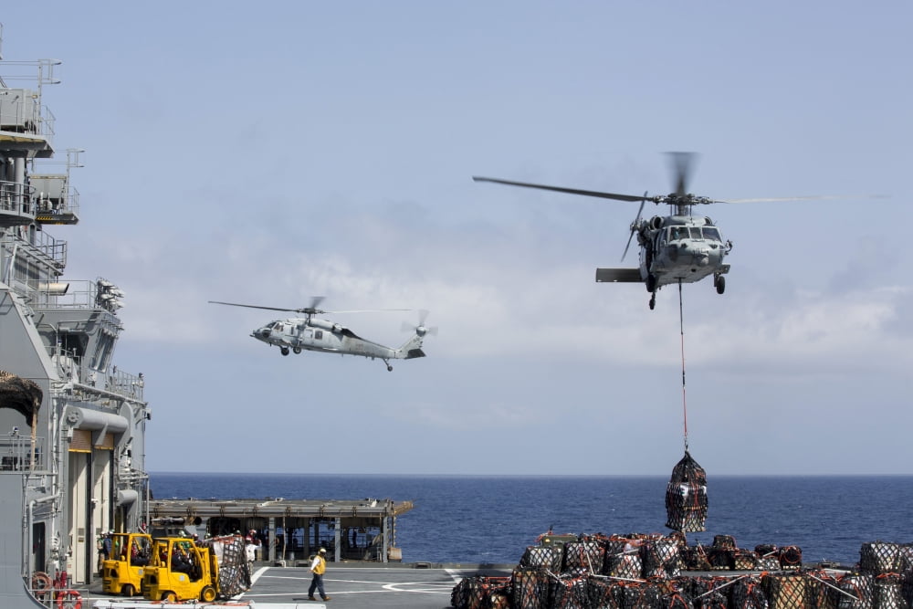 An MH-60S Sea Hawk picks up cargo from USNS Medgar Evers Canvas Art - Stocktrek Images (35 x 23)