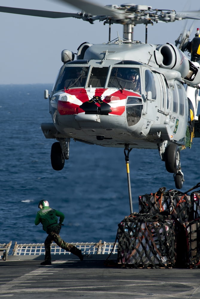 An MH-60S Sea Hawk picks up pallets from the flight deck of of USNS Rainier Canvas Art - Stocktrek Images (23 x 35)
