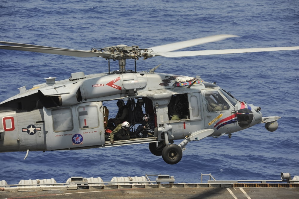 An MH-60S Sea Hawk prepares to land on the flight deck of USS Nimitz Canvas Art - Stocktrek Images (35 x 23)