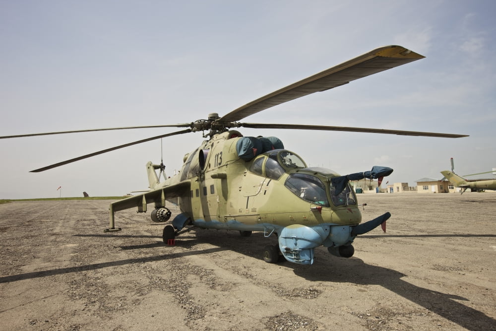 An Mi-35 attack helicopter at Kunduz Airfield Afghanistan Canvas Art - Terry MooreStocktrek Images (18 x 12)