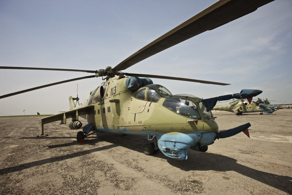 An Mi-35 attack helicopter at Kunduz Airfield Afghanistan Canvas Art - Terry MooreStocktrek Images (18 x 12)