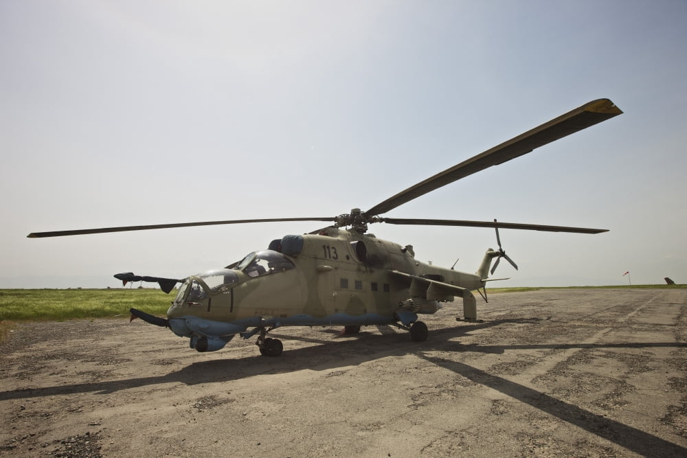 An Mi-35 attack helicopter at Kunduz Airfield Afghanistan Canvas Art - Terry MooreStocktrek Images (35 x 24)