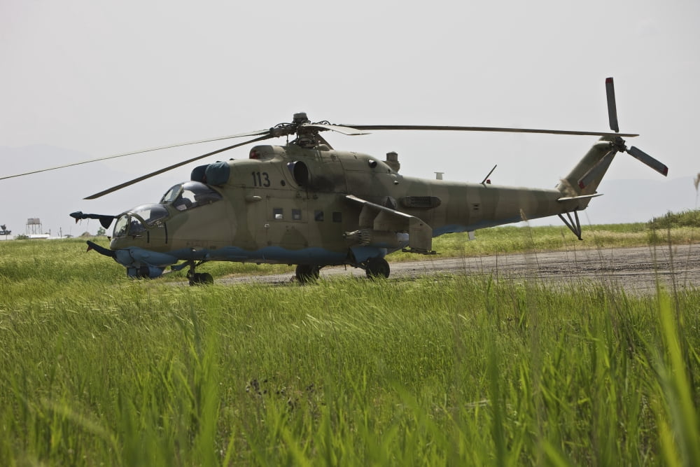 An Mi-35 attack helicopter at Kunduz Airfield Afghanistan Canvas Art - Terry MooreStocktrek Images (35 x 24)