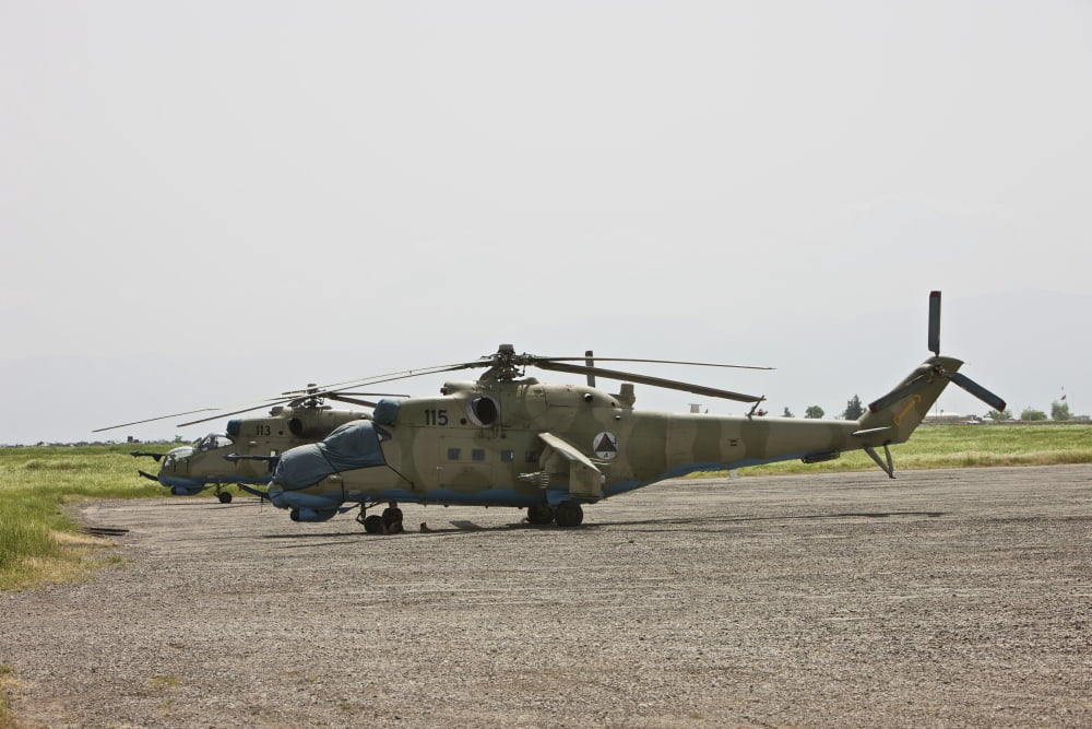 An Mi-35 attack helicopter at Kunduz Airfield Afghanistan Canvas Art - Terry MooreStocktrek Images (35 x 24)