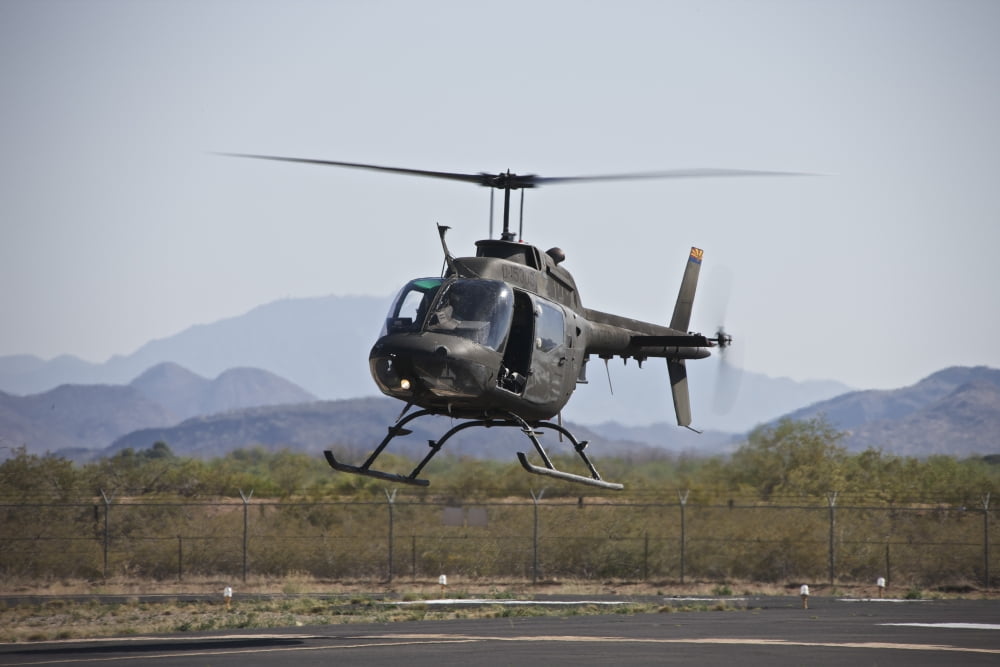 An OH-58 Kiowa helicopter of the US Army landing at Pinal Airpark Arizona Canvas Art - Terry MooreStocktrek Images (18 x 12)