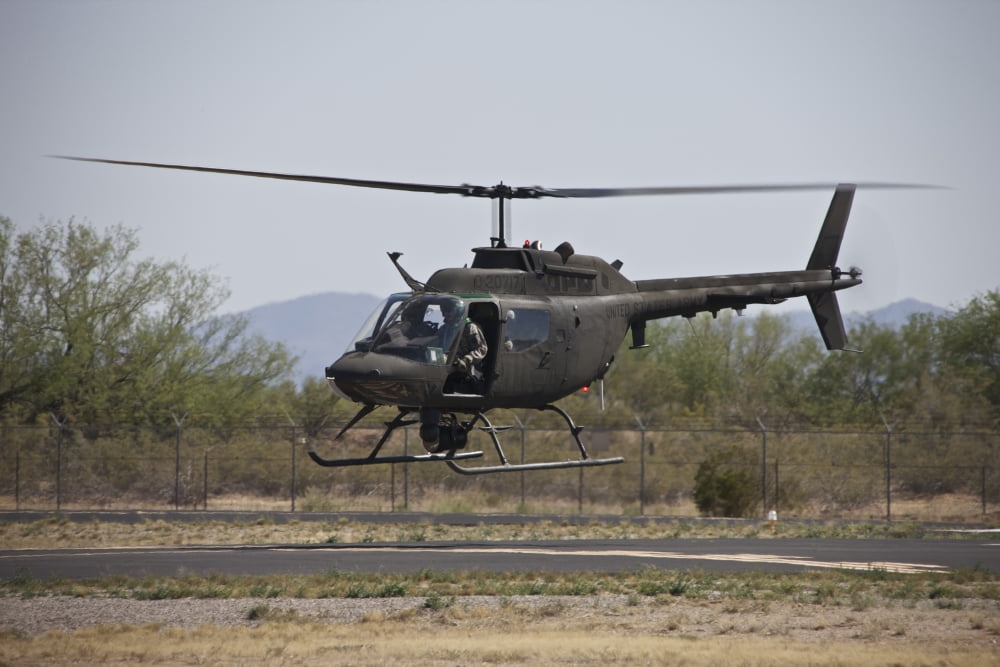 An OH-58 Kiowa helicopter of the US Army landing at Pinal Airpark Arizona Canvas Art - Terry MooreStocktrek Images (18 x 12)