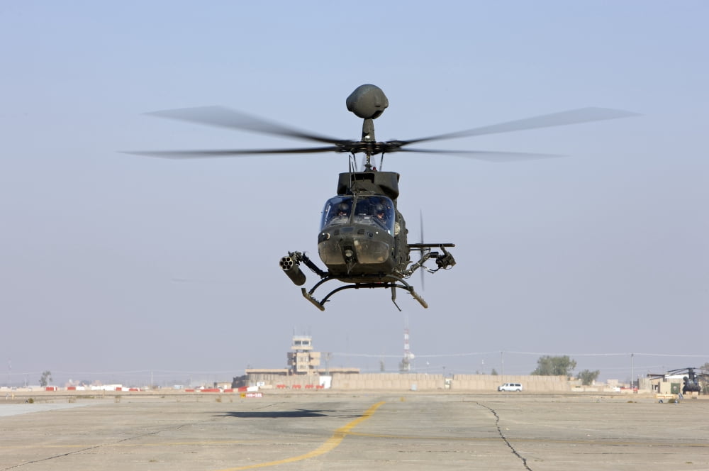 An OH-58D Kiowa Warrior hovers over the flight line at Camp Speicher Iraq Canvas Art - Terry MooreStocktrek Images (18 x 12)