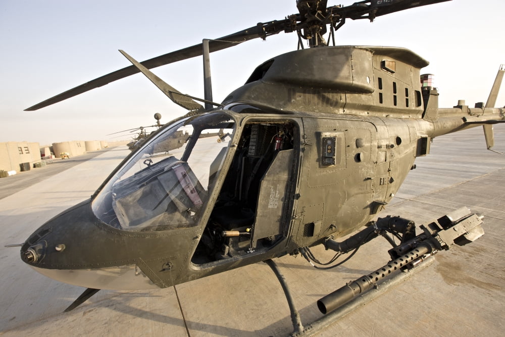 An OH-58D Kiowa helicopter on the tarmac at COB Speicher Iraq Canvas Art - Terry MooreStocktrek Images (18 x 12)