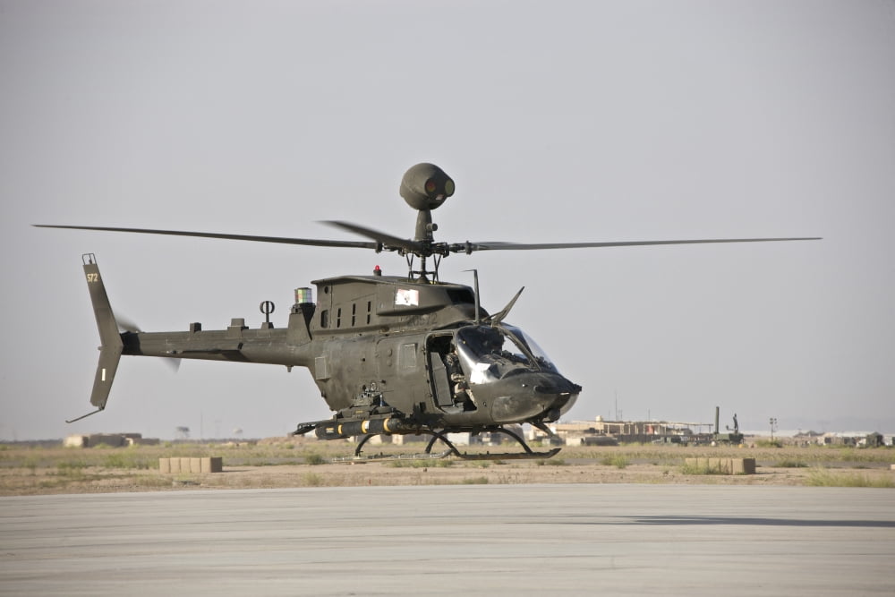 An OH-58D Kiowa helicopter takes off from COB Speicher Canvas Art - Terry MooreStocktrek Images (18 x 12)