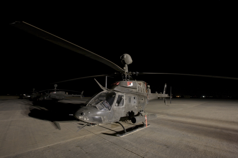 An OH-58D Kiowa sits on its pad at night Canvas Art - Terry MooreStocktrek Images (18 x 12)