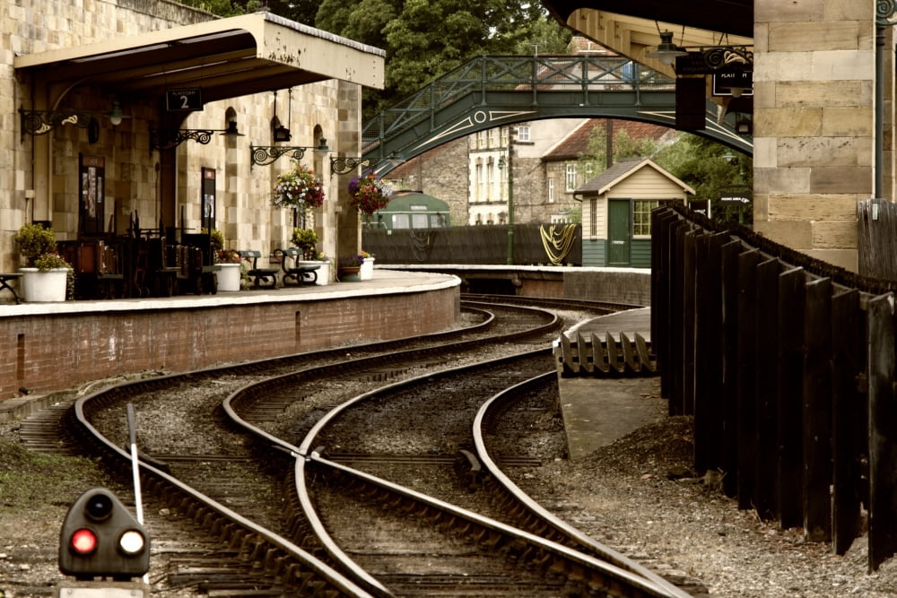 An Old-Fashioned Train Station And Tracks Canvas Art - John Short  Design Pics (34 x 22)