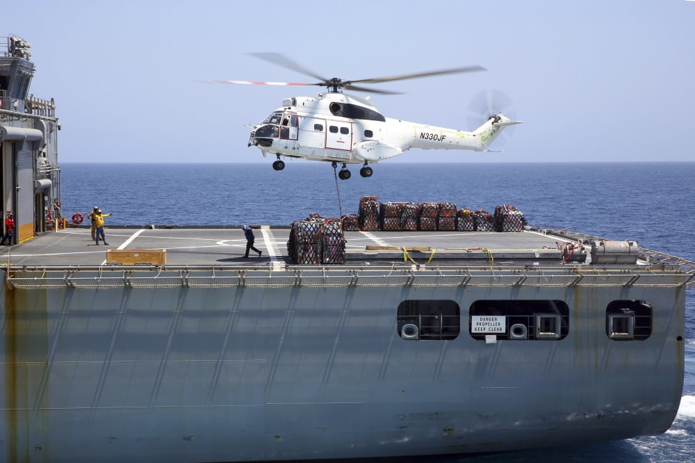 An SA-330J Puma helicopter delivers supplies to USS Kearsarge Canvas Art - Stocktrek Images (35 x 23)