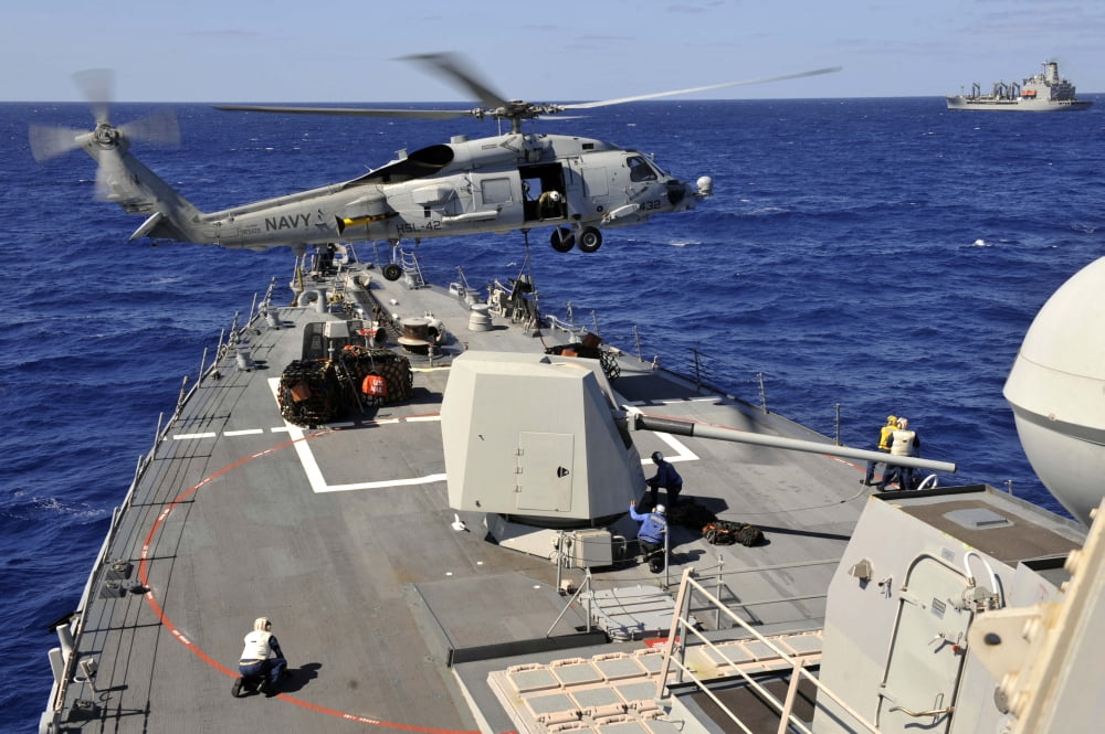 An SH-60B Sea Hawk helicopter picks up a pallet from USS Jason Dunham Canvas Art - Stocktrek Images (35 x 23)
