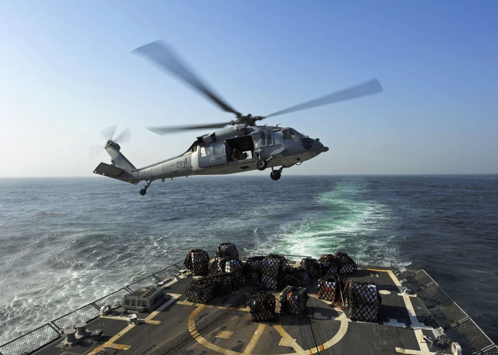 An SH-60R Sea Hawk delivers pallets during a replenishment at sea Canvas Art - Stocktrek Images (33 x 24)