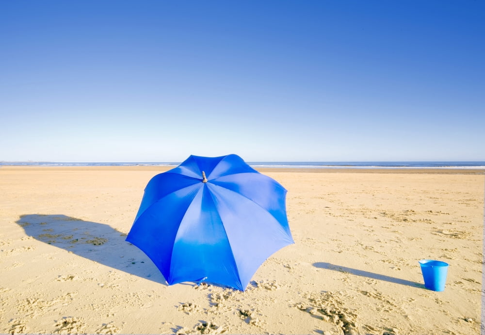 An Umbrella And A Pail On The Beach Canvas Art - John Short Design Pics (16 x 11)