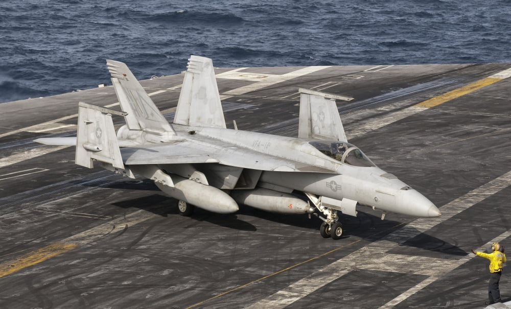 An aircraft director guides an FA-18F Super Hornet aboard aircraft carrier USS Nimitz Canvas Art - Giovanni CollaStocktrek Images (37 x 22)