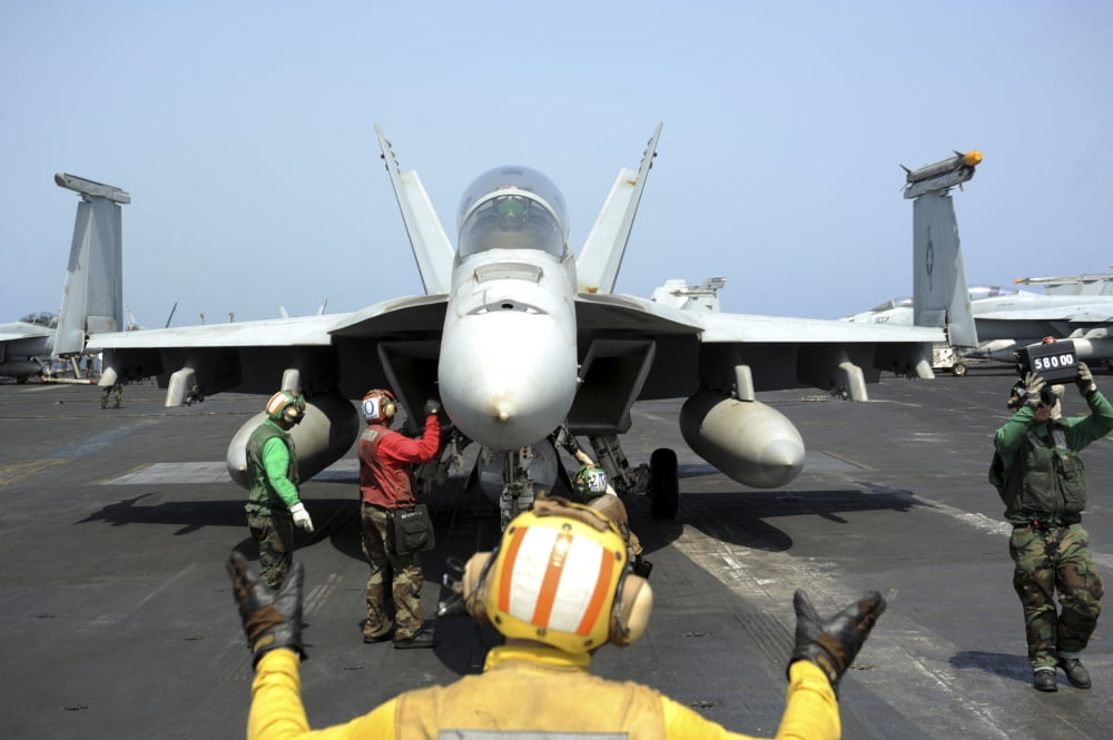 An aircraft director signals to the pilot of an FA-18F Super Hornet Canvas Art - Stocktrek Images (35 x 23)