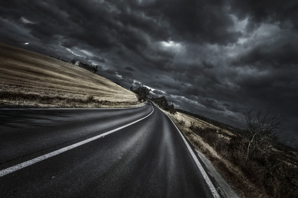 An asphalt road with stormy sky above Tuscany Italy Canvas Art - Evgeny KuklevStocktrek Images (35 x 23)