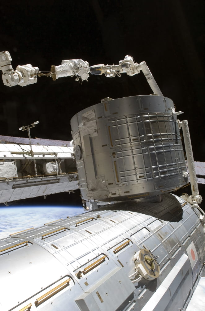 An astronaut anchored to a mobile foot restraint participates in a session of extravehicular activity Canvas Art - Stocktrek Images (23 x 34)