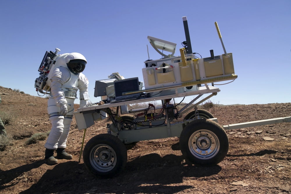 An astronaut equipped with a Mark-III suit pauses at the rear of a science trailer Canvas Art - Stocktrek Images (34 x 23)