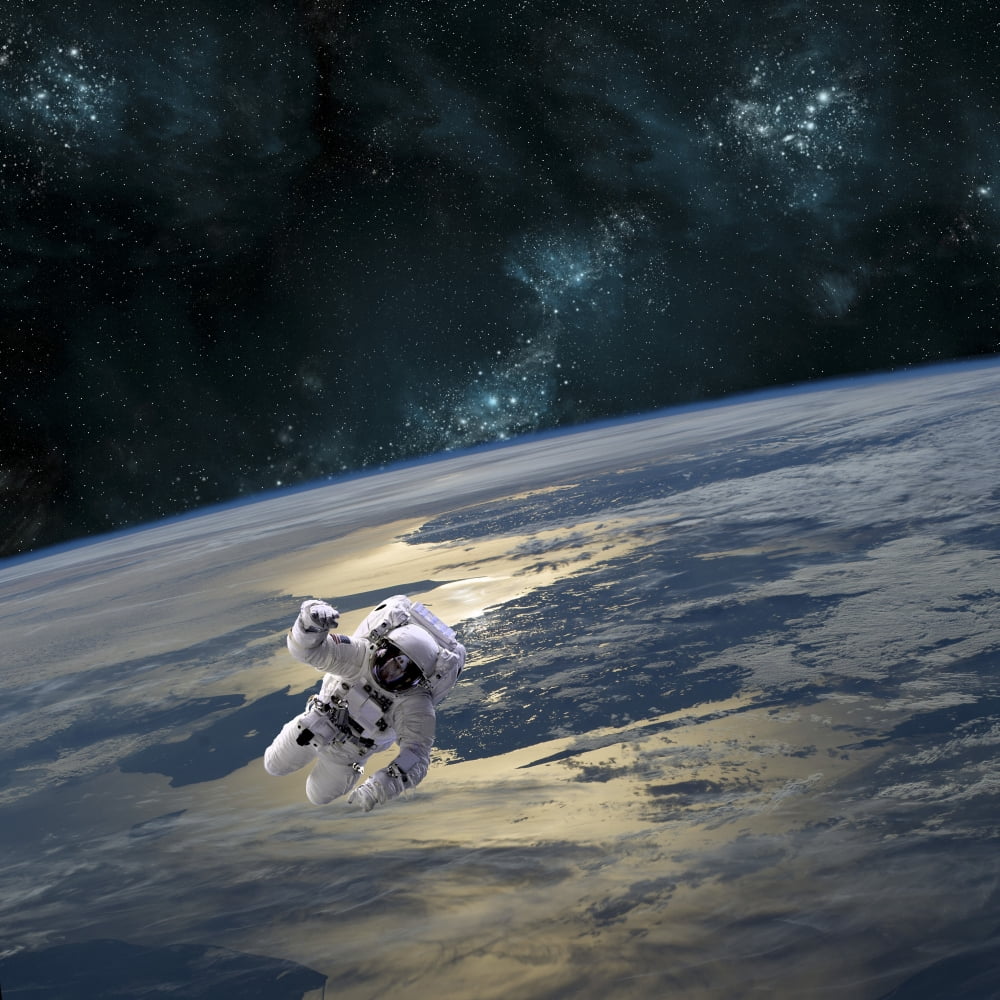 An astronaut floating above Earth Canvas Art - Marc WardStocktrek Images (29 x 29)