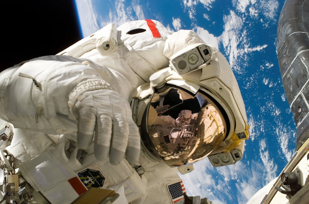 An astronaut mission specialist participates in extravehicular activity Canvas Art - Stocktrek Images (34 x 23)