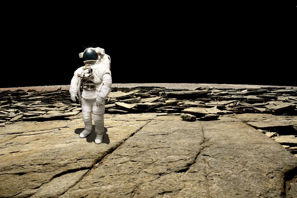 An astronaut on a barren planet Canvas Art - Marc WardStocktrek Images (35 x 24)