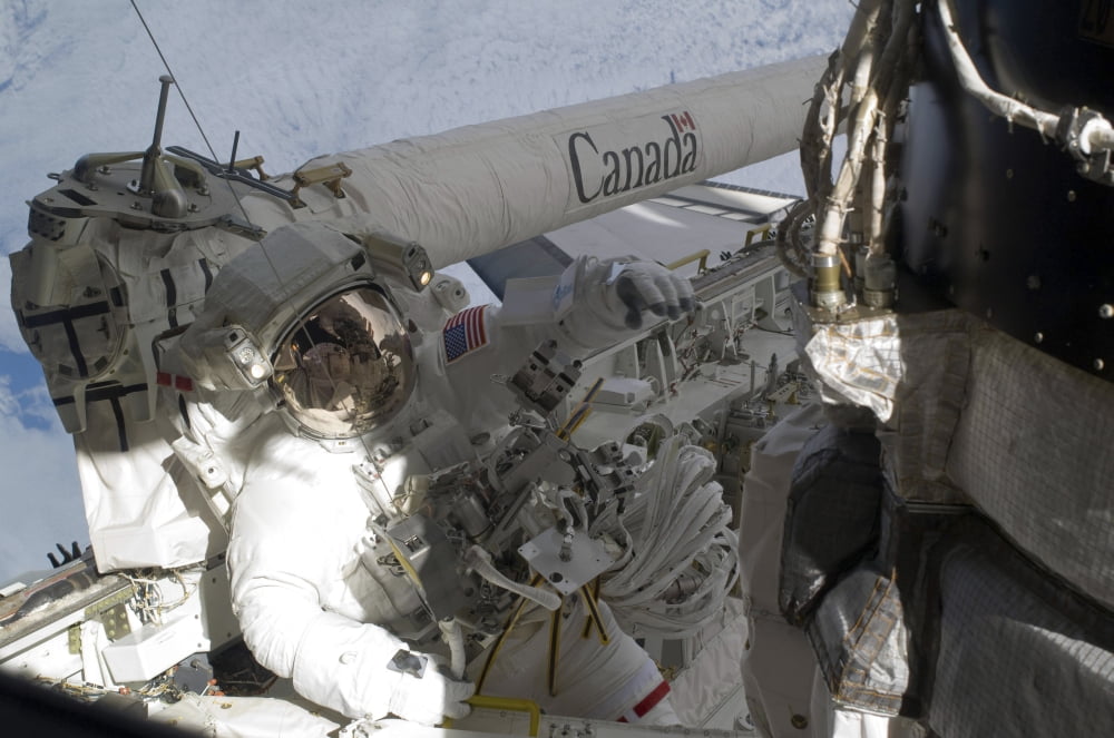 An astronaut on the starboard side of the cargo bay of space shuttle Atlantis Canvas Art - Stocktrek Images (35 x 23)