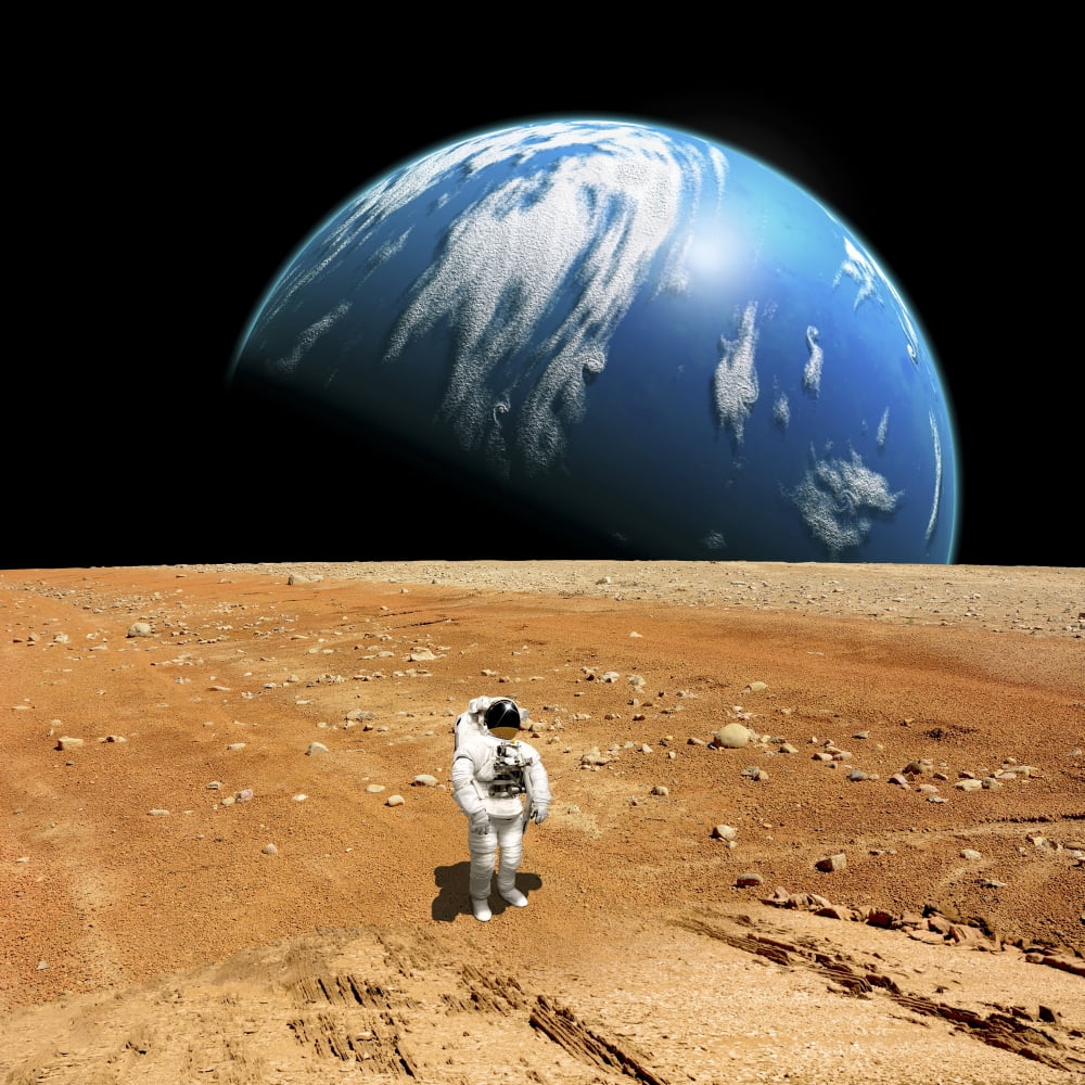 An astronaut standing on a barren world with planet rising in background Canvas Art - Marc WardStocktrek Images (29 x 29)